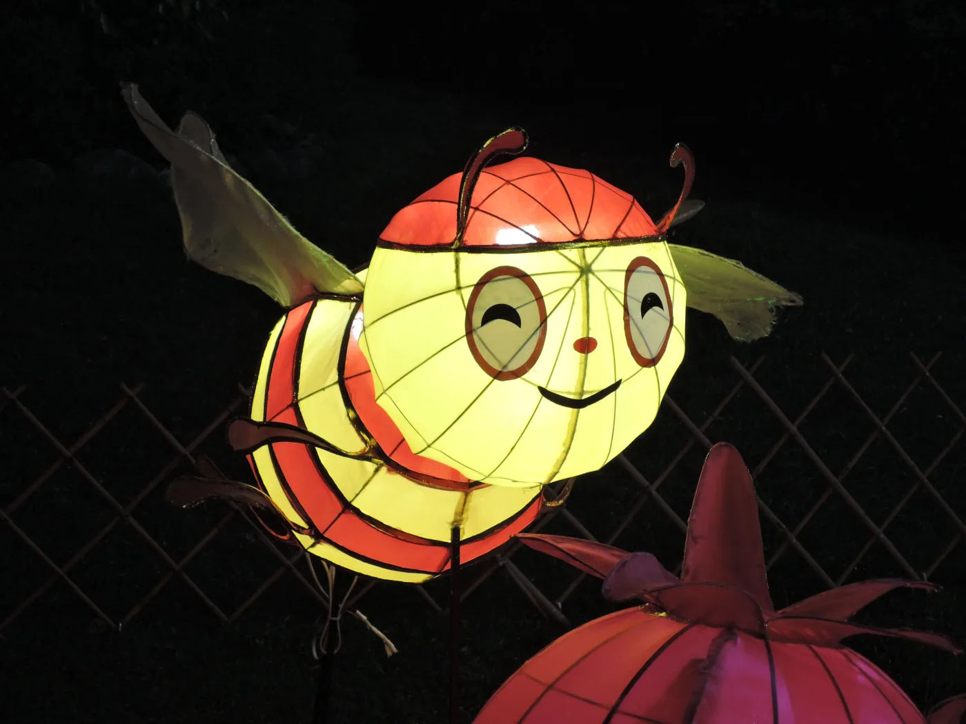 An illuminated honey-bee lantern in a colorful night-time display at Tuen Mun Park, Hong Kong