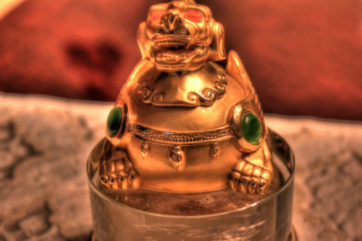 A gold-colored Pixiu ornament photographed at close range